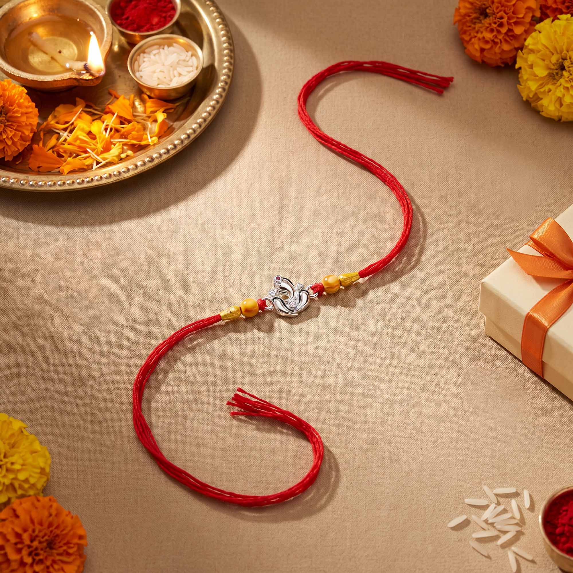 Silver Ganesha Lotus Red Thread Rakhi