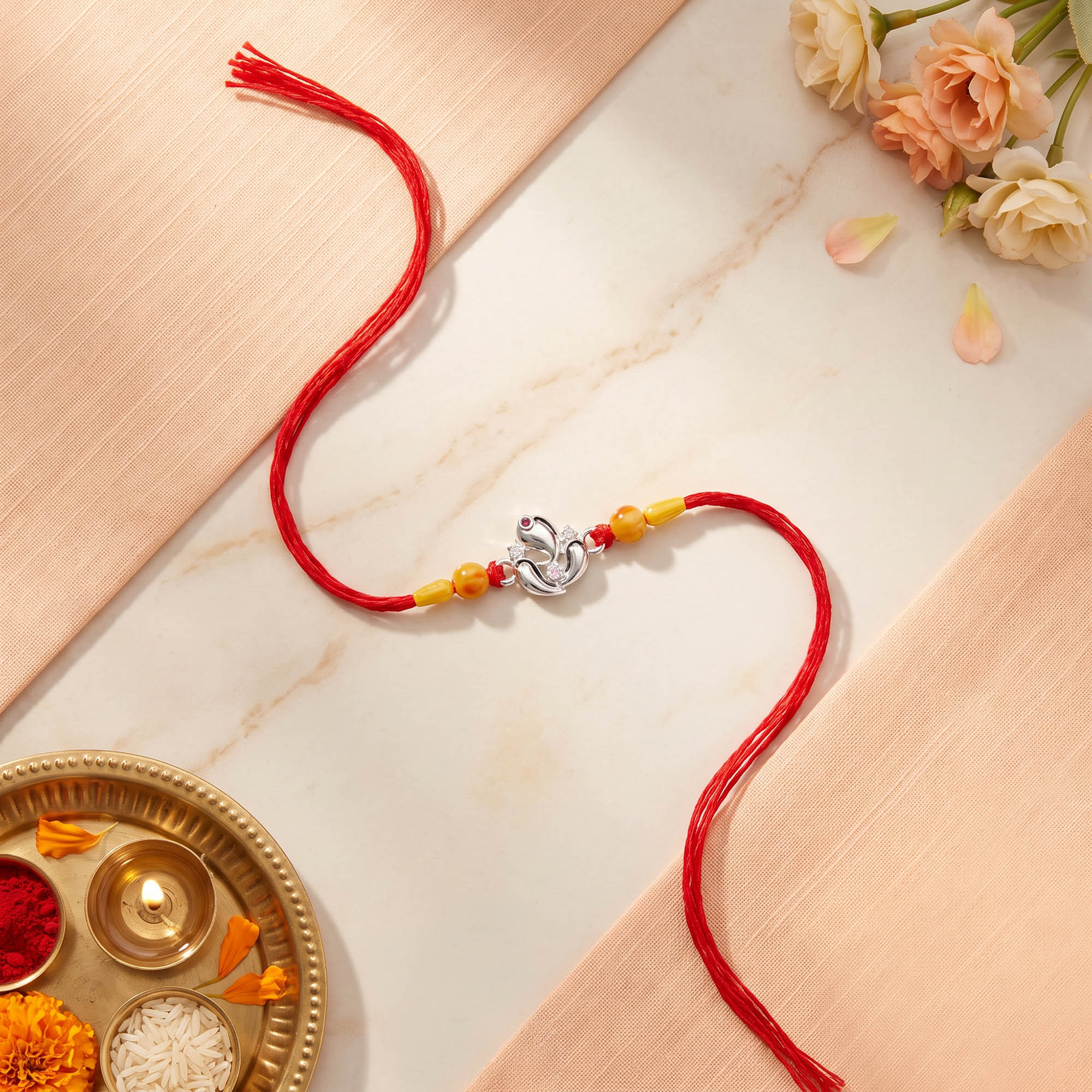 Silver Ganesha Lotus Red Thread Rakhi