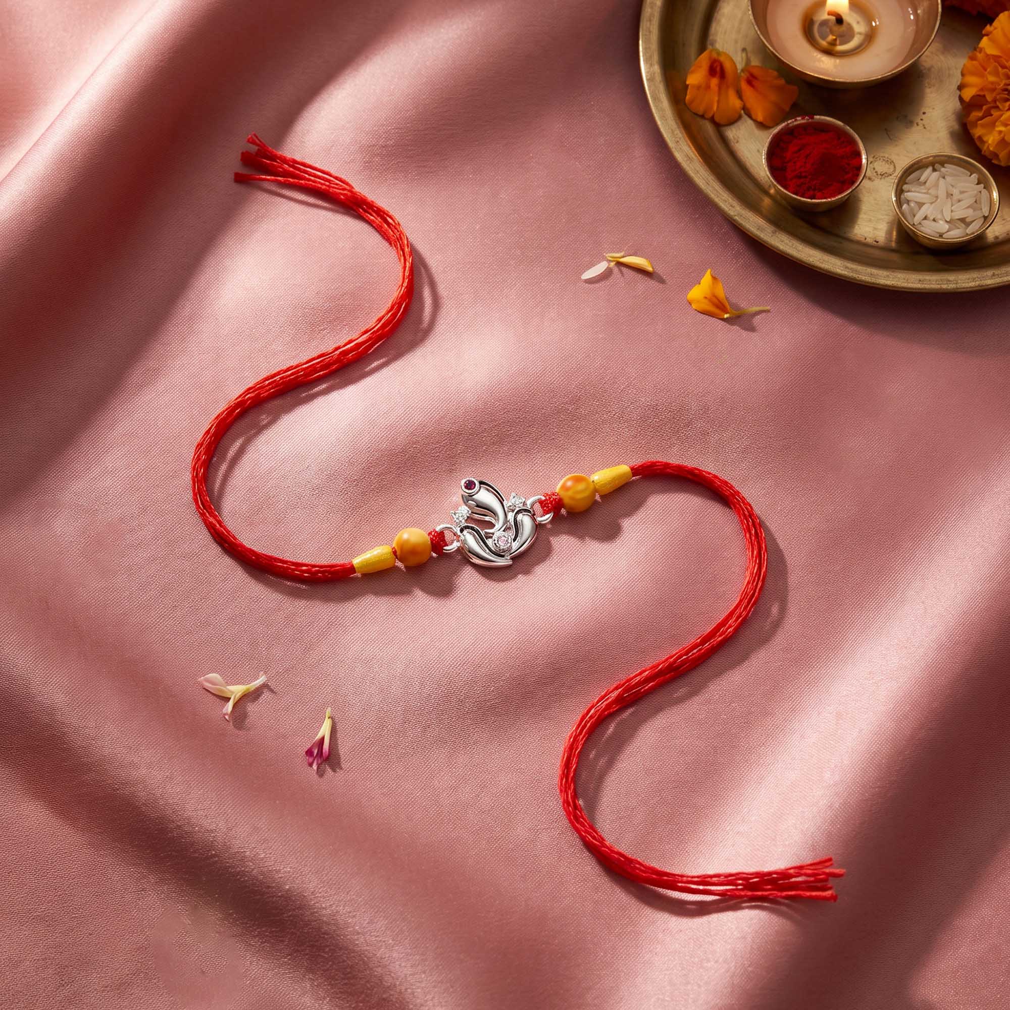 Silver Ganesha Lotus Red Thread Rakhi