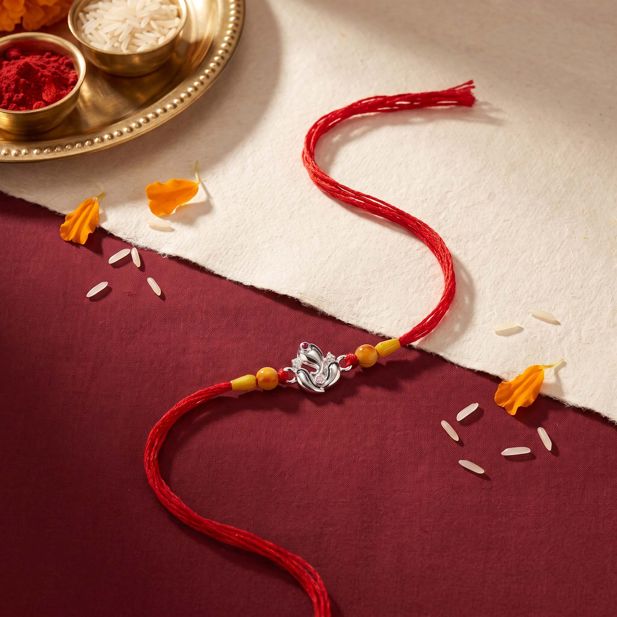 Silver Ganesha Lotus Red Thread Rakhi