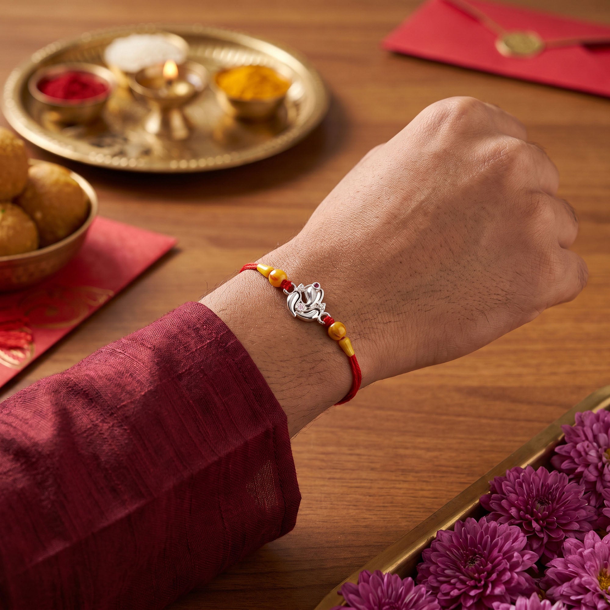 Silver Ganesha Lotus Red Thread Rakhi